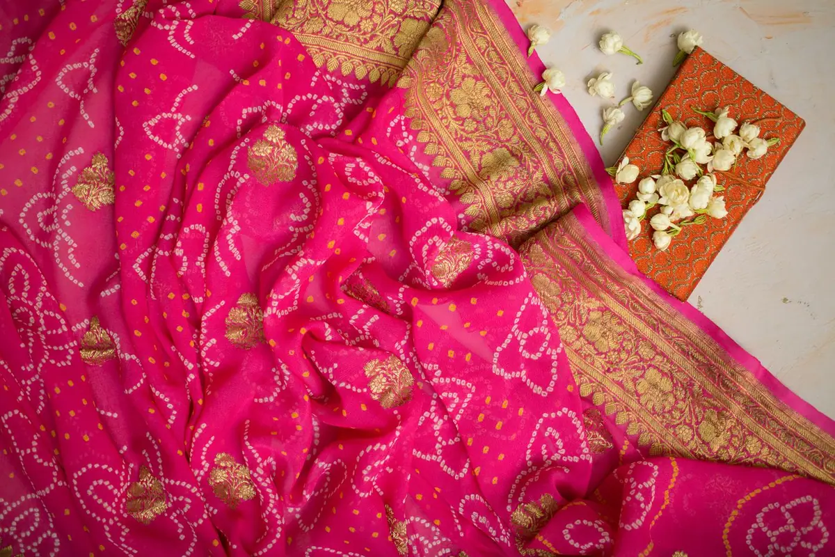 Gold floral embroidery on saturated pink cloth
